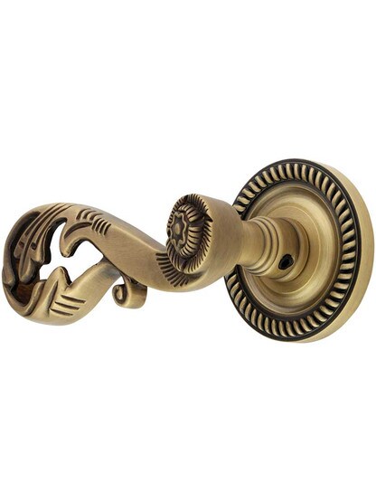 Charleston Rosette with Champagne Door Levers in Antique Brass.